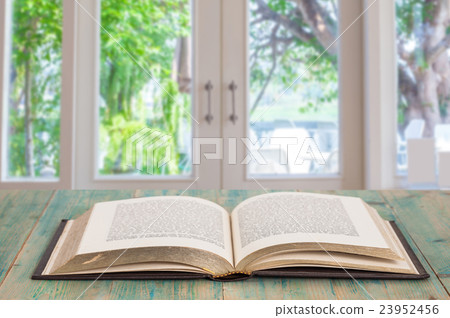 Open old book on wood Open old book on wood 23952456