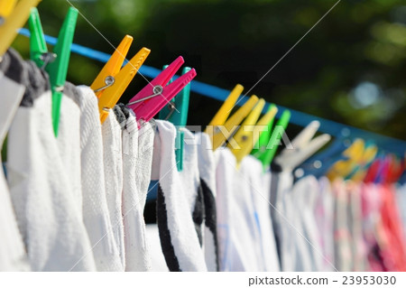 Drying clothes hanged on the clothesline.  23953030