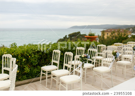 Original white chairs stand on the porch Original white chairs stand on the porch 23955108
