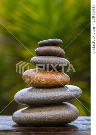 stack of round smooth wet pebbles 23956433