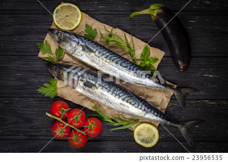 Mackerels served on parchment with lemon, tomatoes 23956535