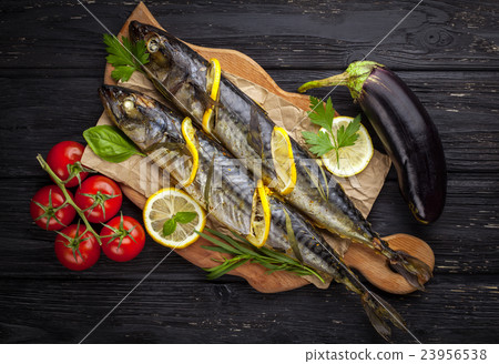 grilled mackerels on the black wooden table with 23956538