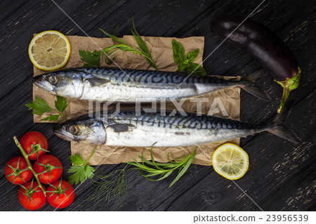 Mackerels served on parchment with lemon, tomatoes 23956539