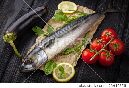 Mackerels served on parchment with lemon, tomatoes 23956556