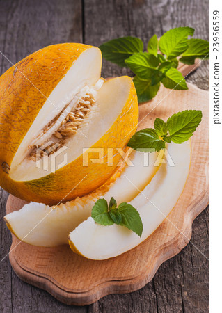 Fresh sweet orange melon on the wooden table 23956559