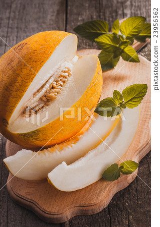 Fresh sweet orange melon on the wooden table 23956562