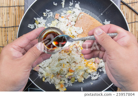 Chef putting soy sauce for cooking fried rice Chef putting soy sauce for cooking fried rice 23957804