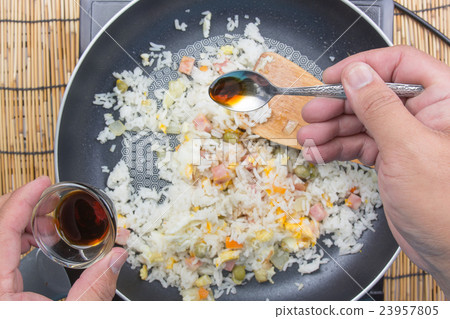 Chef putting soy sauce for cooking fried rice Chef putting soy sauce for cooking fried rice 23957805