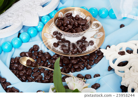 chocolate dragees in a still life blue colors chocolate dragees in a still life blue colors 23958244