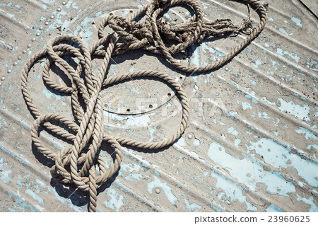 Knotted mooring rope on boat deck Knotted mooring rope on boat deck 23960625