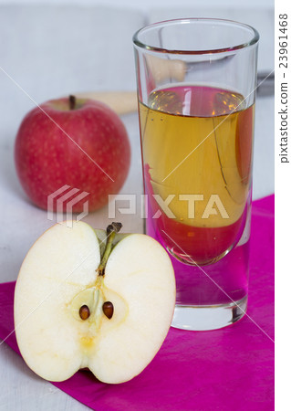 Apple juice freshly squeezed in glass on wood 23961468