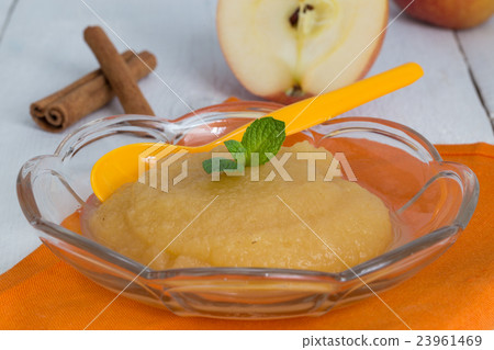 Applesauce with cinnamon and orange spoon 23961469