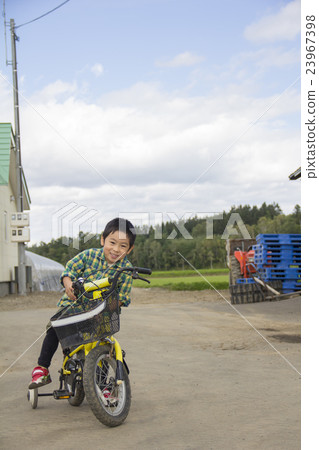 A boy riding a bicycle A boy riding a bicycle 23967398