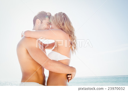 Smiling young couple hugging Smiling young couple hugging 23970032