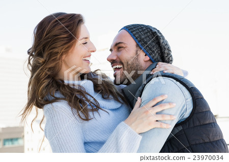 Happy couple cuddling each other Happy couple cuddling each other 23970034