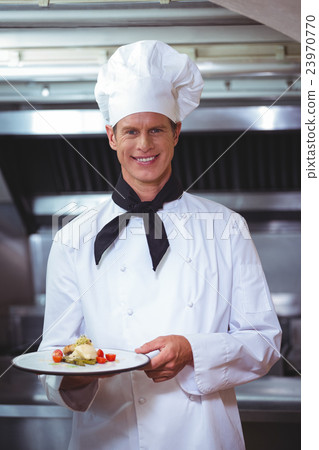 Proud chef holding a plate Proud chef holding a plate 23970770