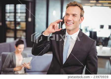 Businessman talking on mobile phone Businessman talking on mobile phone 23970939