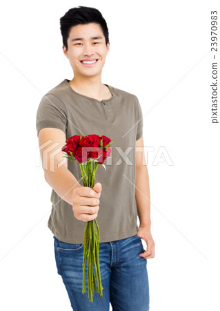 Happy young man holding bunch of red roses Happy young man holding bunch of red roses 23970983