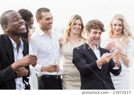 Well dressed people looking smartphone 23972017