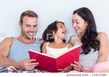 Happy family in their bedroom 23972486