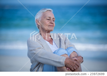 Thoughtful mature woman day dreaming Thoughtful mature woman day dreaming 23972699
