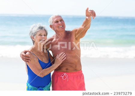 Cute mature couple embracing on the beach Cute mature couple embracing on the beach 23973279