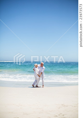 Senior couple dancing at the beach Senior couple dancing at the beach 23973573