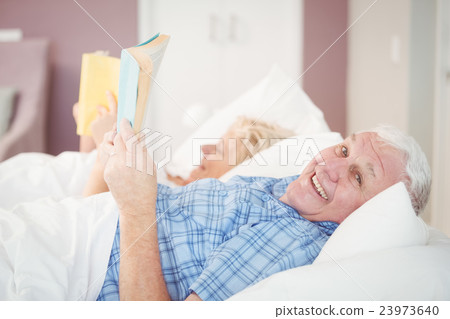 Portrait of senior man holding book Portrait of senior man holding book 23973640
