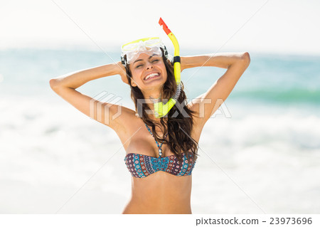Smiling woman posing at the beach Smiling woman posing at the beach 23973696