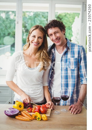 Portrait of smiling young couple in kitchen 23974260