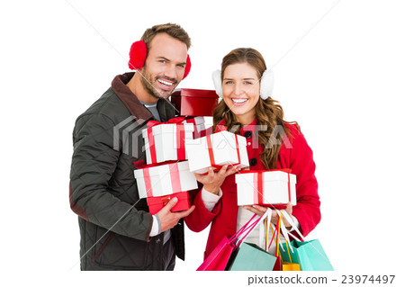 Happy young couple holding gifts and shopping bags Happy young couple holding gifts and shopping bags 23974497