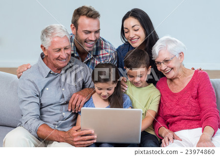 Happy family sitting on sofa 23974860