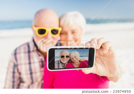 Senior couple taking selfie Senior couple taking selfie 23974950