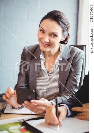 Businesswoman using mobile phone Businesswoman using mobile phone 23975408