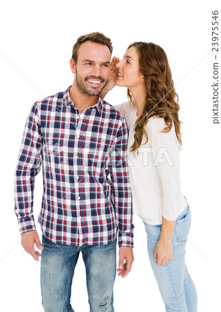 Woman whispering into mans ears Woman whispering into mans ears 23975546