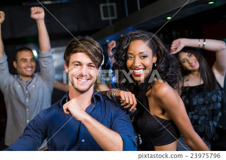 Happy friends dancing together Happy friends dancing together 23975796
