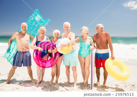 Senior friends with beach accessories Senior friends with beach accessories 23976513