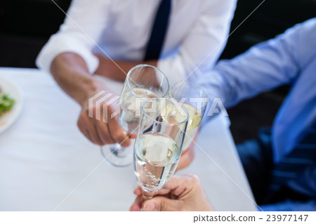 Hands toasting champagne flutes 23977147