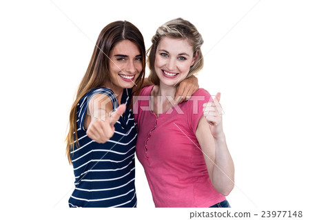 Portrait of happy female friends showing thumbs up 23977148