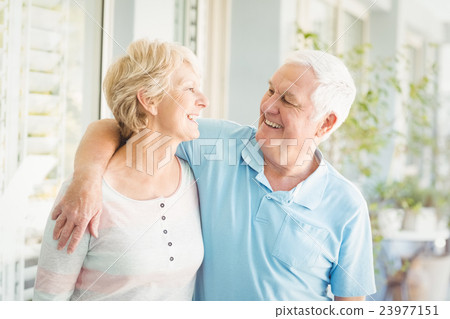Smiling romantic senior couple at home 23977151
