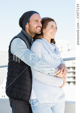 Happy young couple embracing 23977234