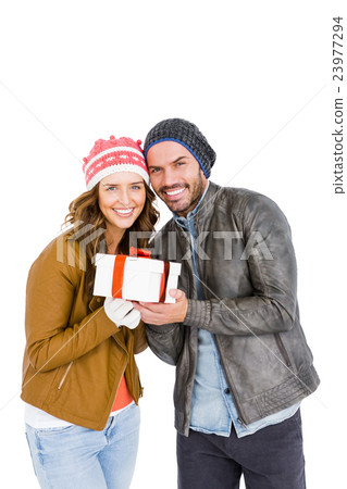 Happy young couple holding gift Happy young couple holding gift 23977294