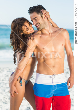 Happy couple hugging on the beach Happy couple hugging on the beach 23977296