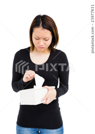 Woman taking a tissue from tissue box 23977631