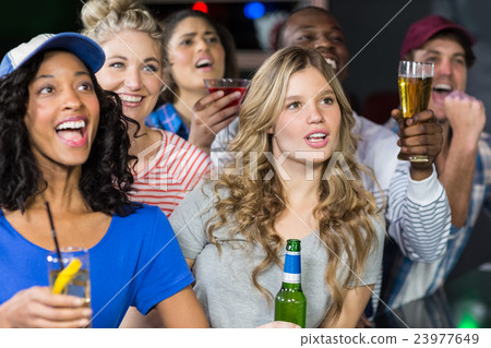 Happy friends watching sport 23977649