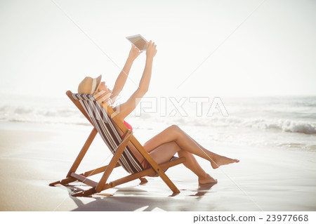 Woman talking a selfie on a digital tablet 23977668