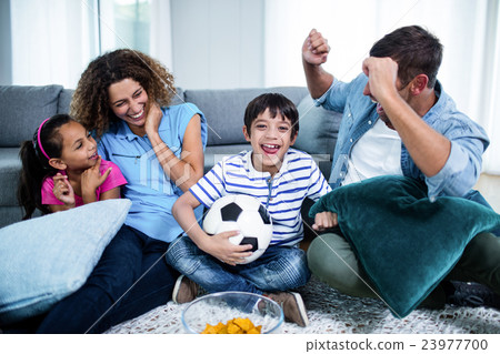 Family watching match together on television Family watching match together on television 23977700