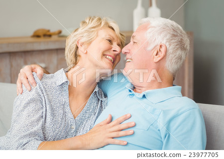 Happy senior couple looking at eachother while hugging 23977705