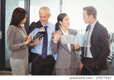 Businesspeople interacting in office 23977932