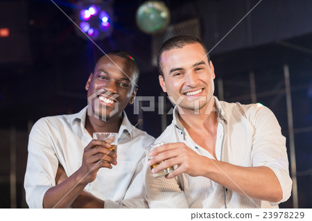 Handsome men drinking together Handsome men drinking together 23978229
